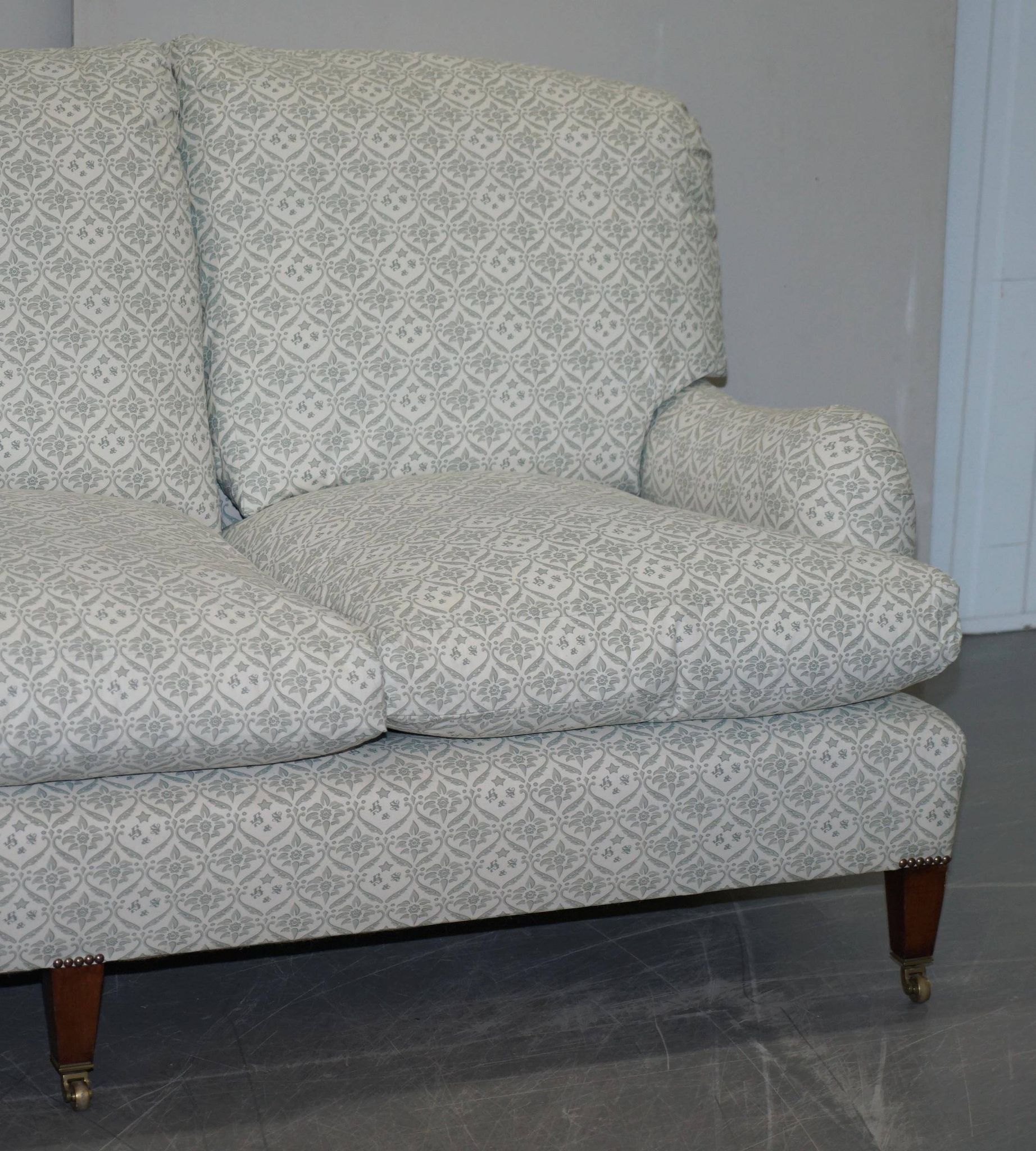 Howard & Sons canapé with feather cushions and ticking fabric, Victorian style.