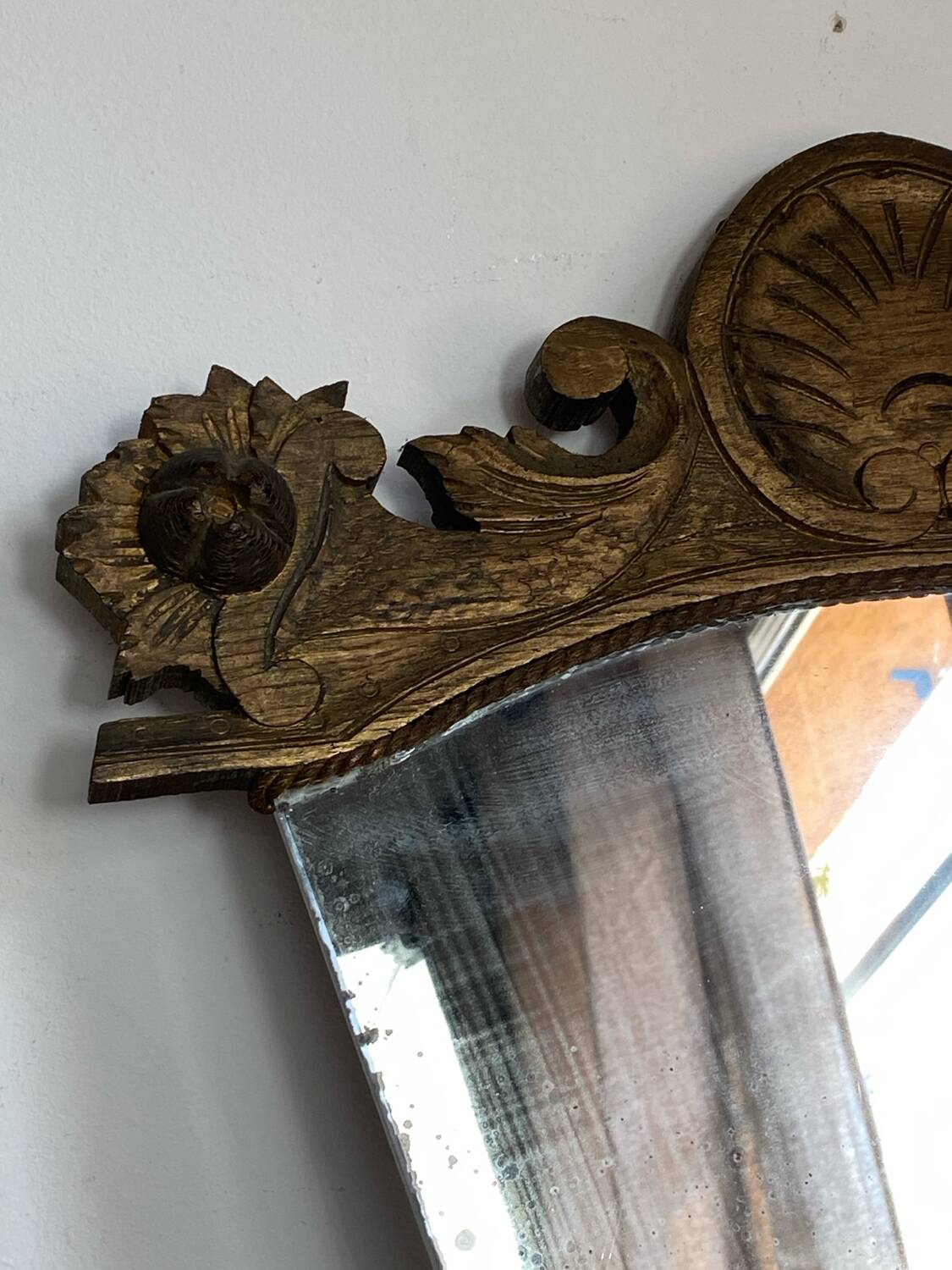 Antique wooden mirror with an unusual shape