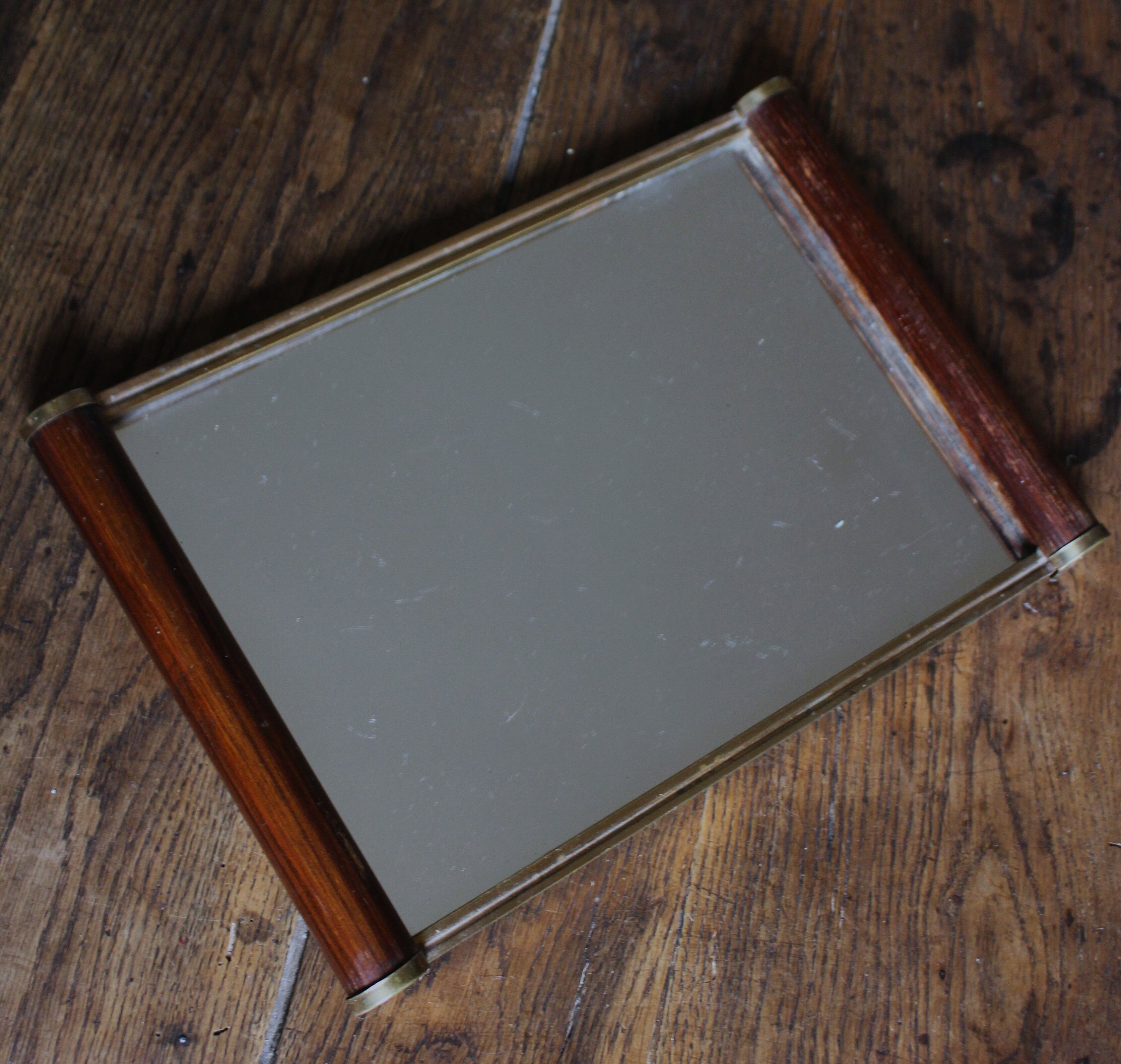 Rectangular mirror tray with wooden handles and gilding.
