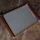 Rectangular mirror tray with wooden handles and gilding.