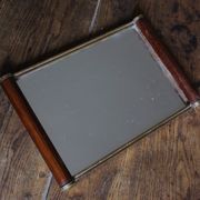 Rectangular mirror tray with wooden handles and gilding.