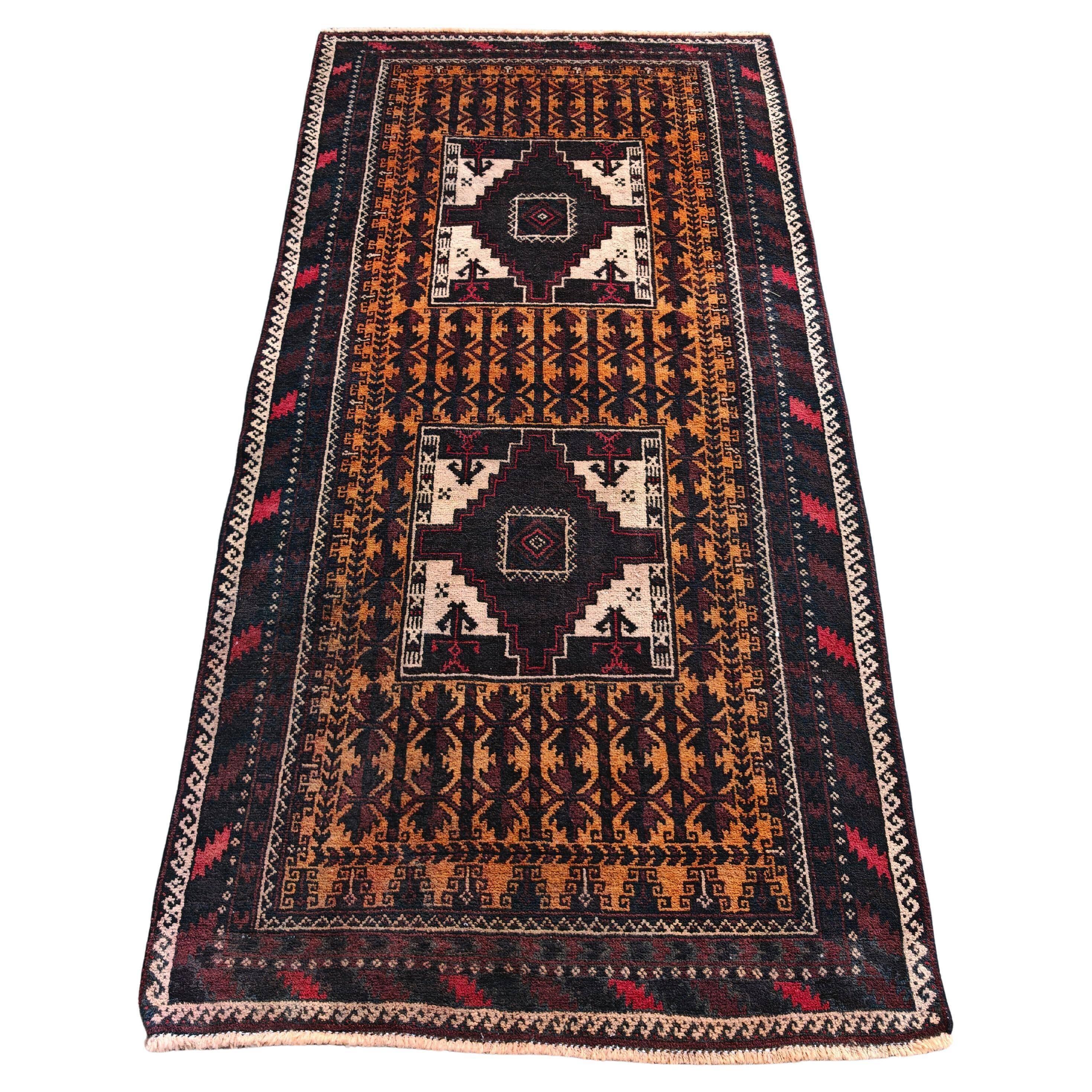 Vintage Persian Baluch rug, hand-knotted wool, 1970.
