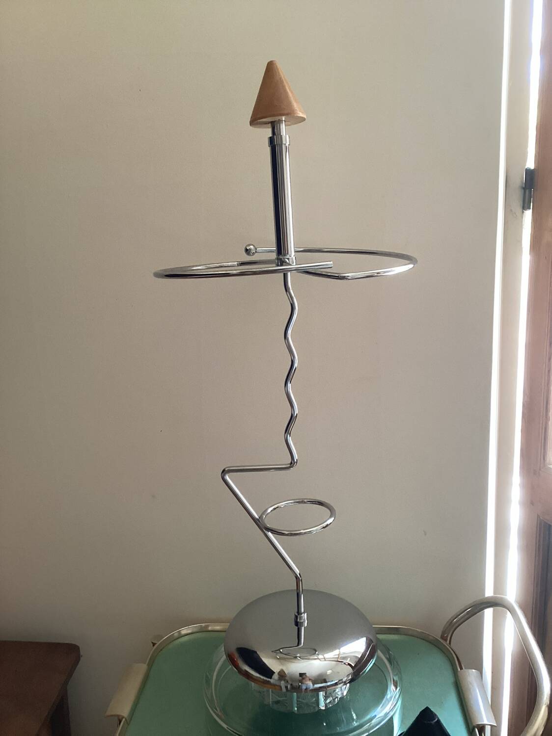 Designer umbrella stand in chrome metal and wood.