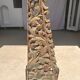 Indonesian construction element in carved wood with intertwined plant motifs mounted on a base (fri