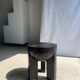 Black mango wood tripod side table with a semi-spherical top, height: 45 cm, diameter: 44 cm.