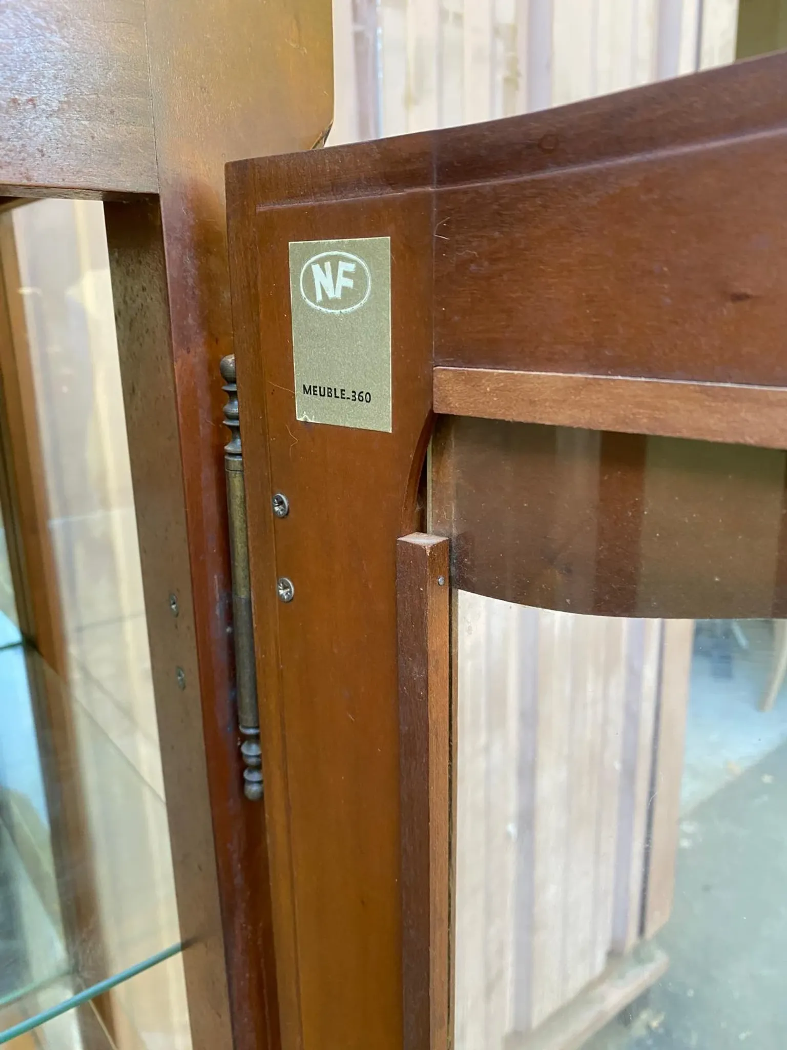 Louis XV style display cabinet in cherry wood with a mirrored back and glass shelves.