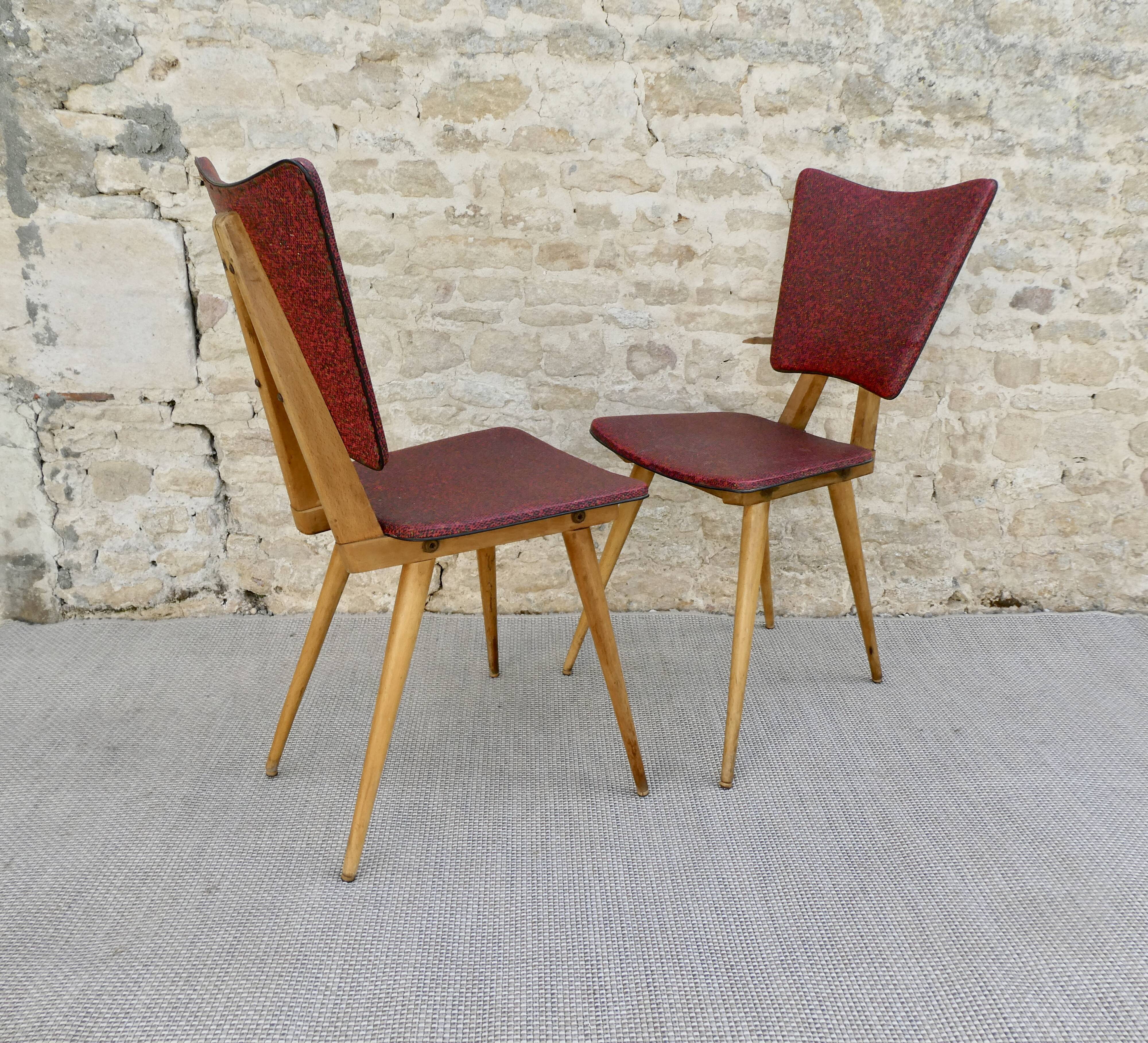 Pair of wooden chairs and red skai, 50s