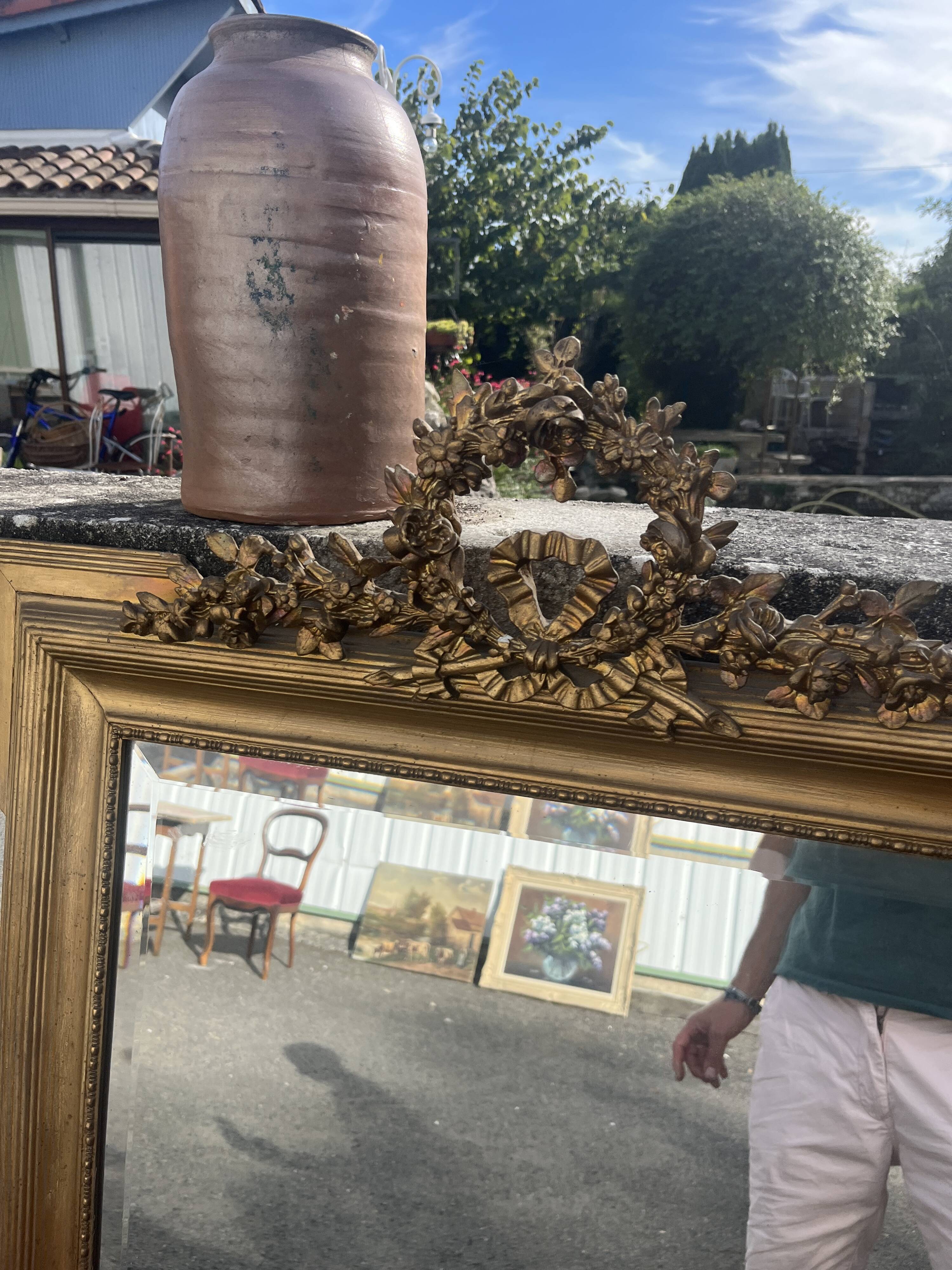 Large antique gilded mirror with carved pediment, 126 cm