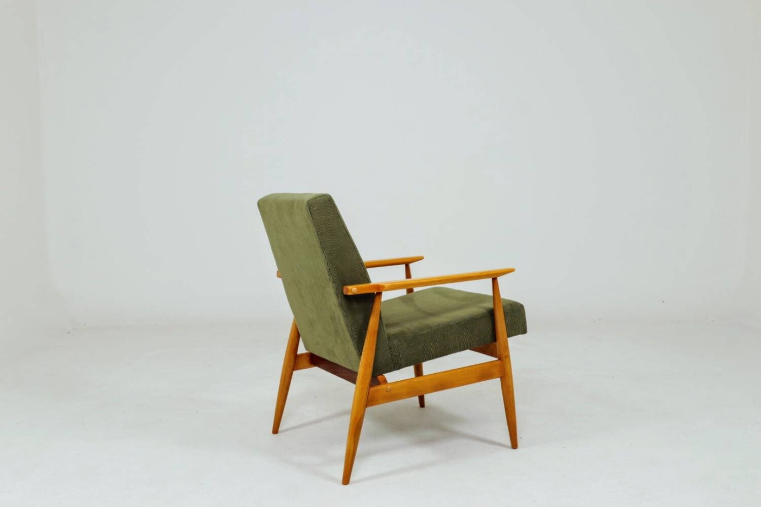 Mid-century modern design armchair in olive green corduroy.
