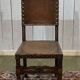 High-backed chair from the early 20th century in oak and leather