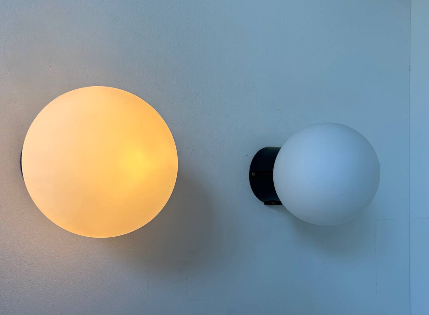 Pair of vintage Raak opaline and Bakelite wall lights, Netherlands 1970s