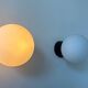 Pair of vintage Raak opaline and Bakelite wall lights, Netherlands 1970s