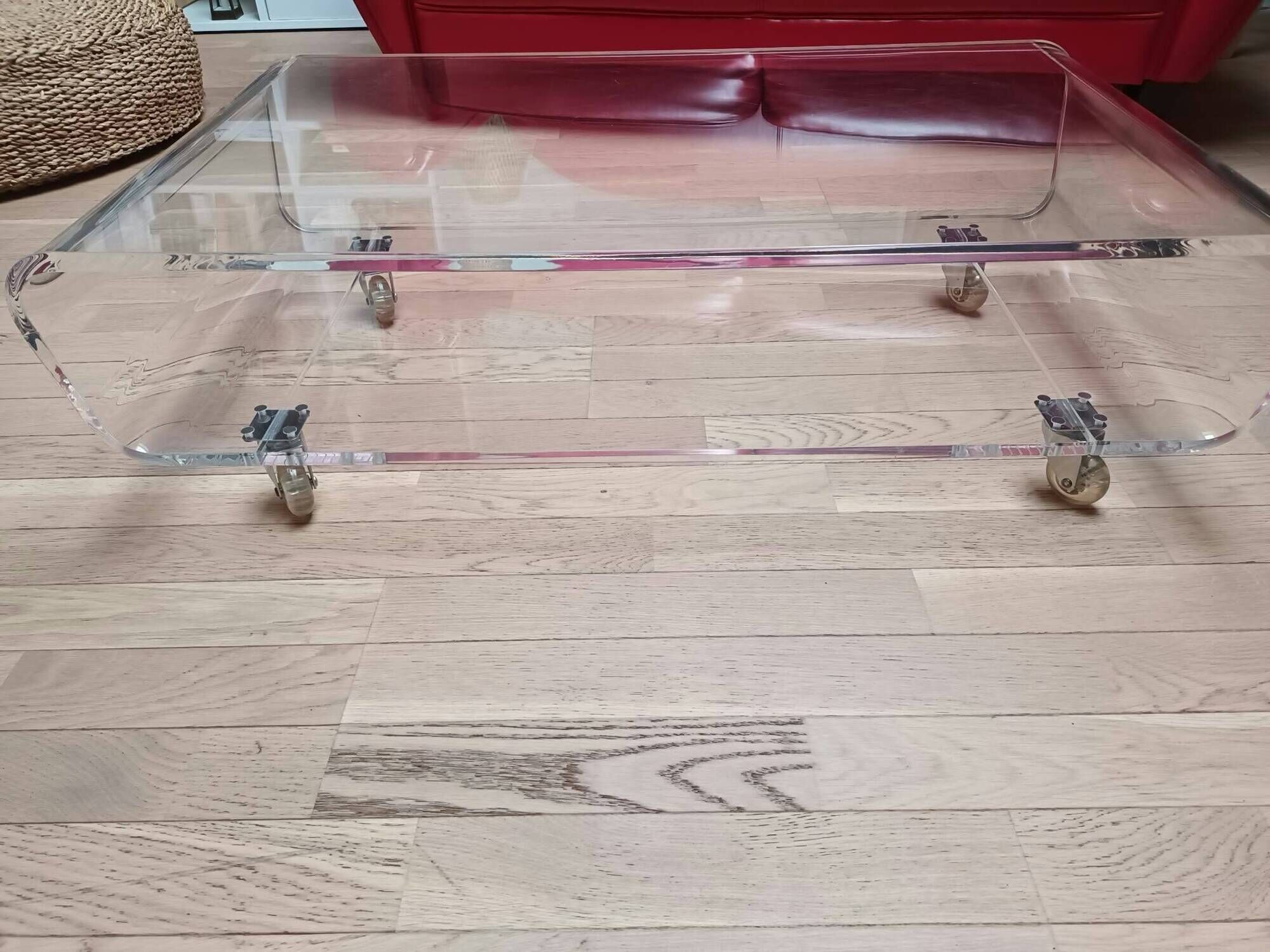 Design coffee table from Habitat in transparent plexiglass, mounted on wheels.