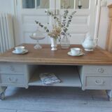 Coffee table on casters, made from an old desk, pearl gray base and belt.