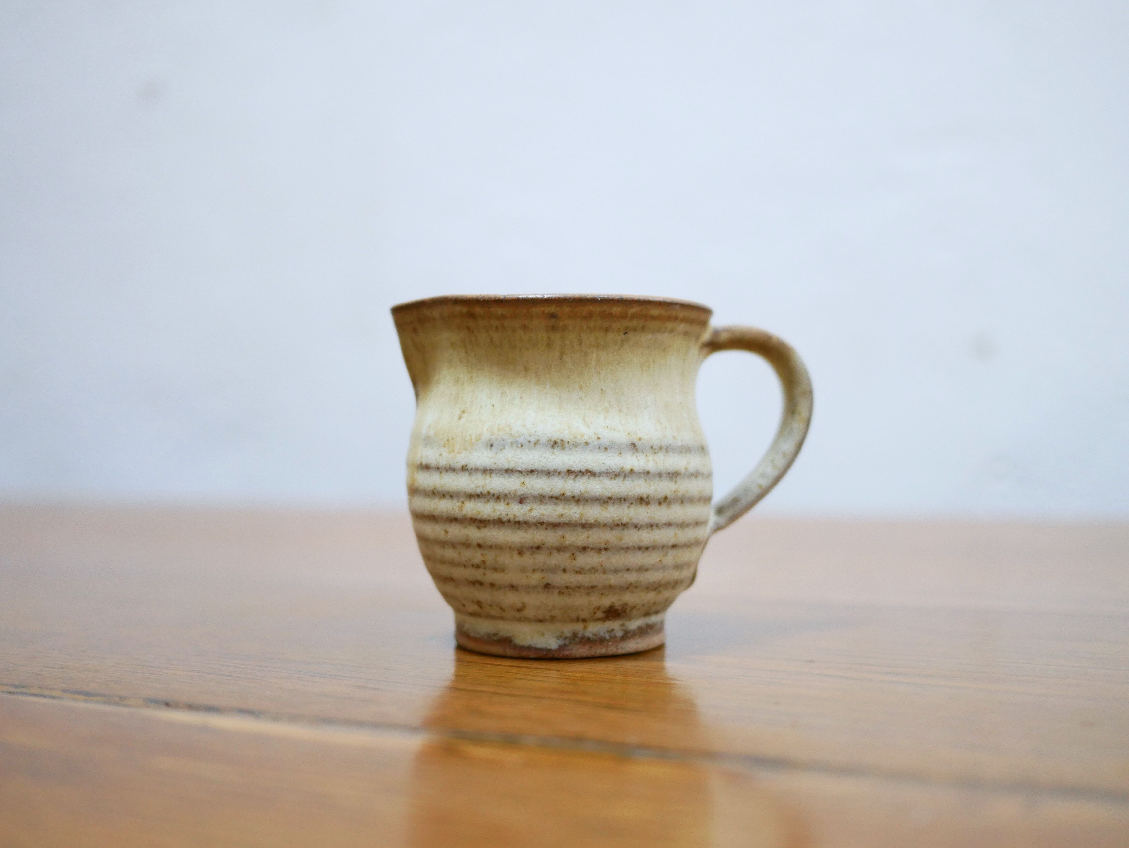 Series of 4 cups and a vintage stoneware milk jug