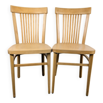 A pair of vintage bistro chairs.