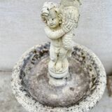 Beautiful old stone garden fountain with child statue