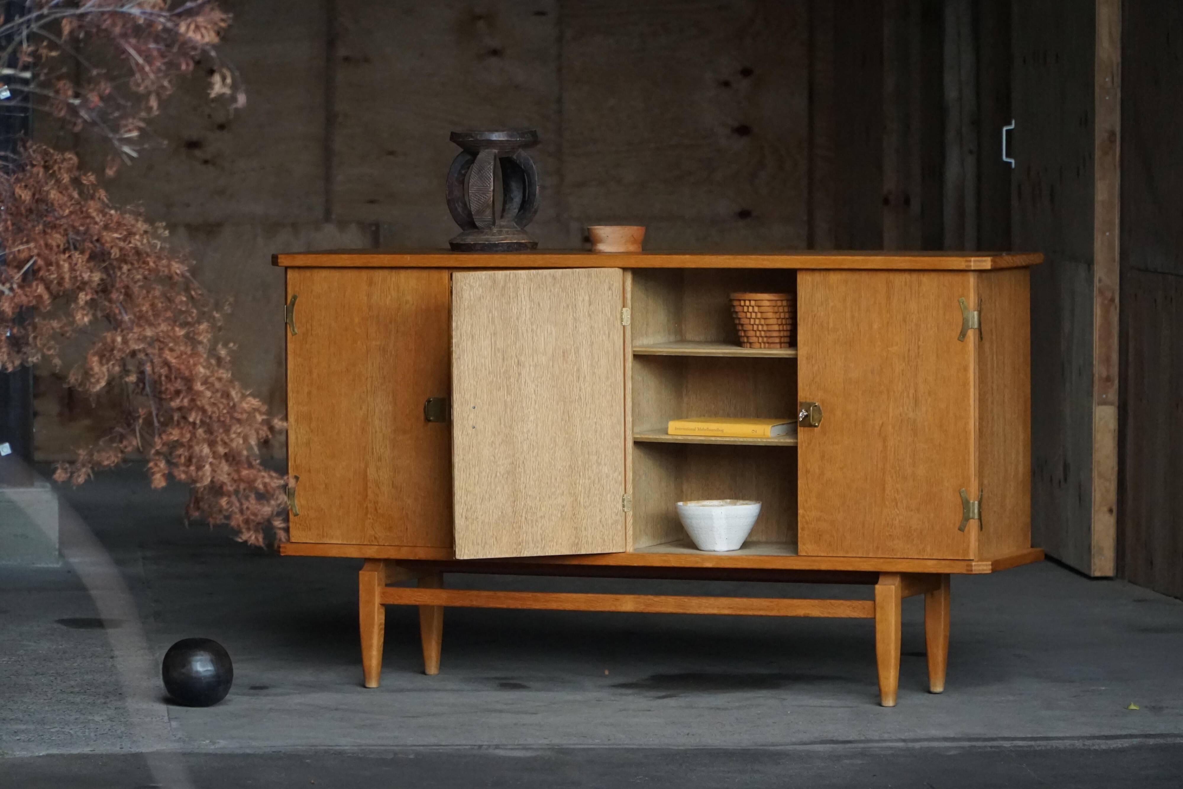 Oak and brass buffet by Henning Kjærnulf, Mid-century modern Danish, 1960s.