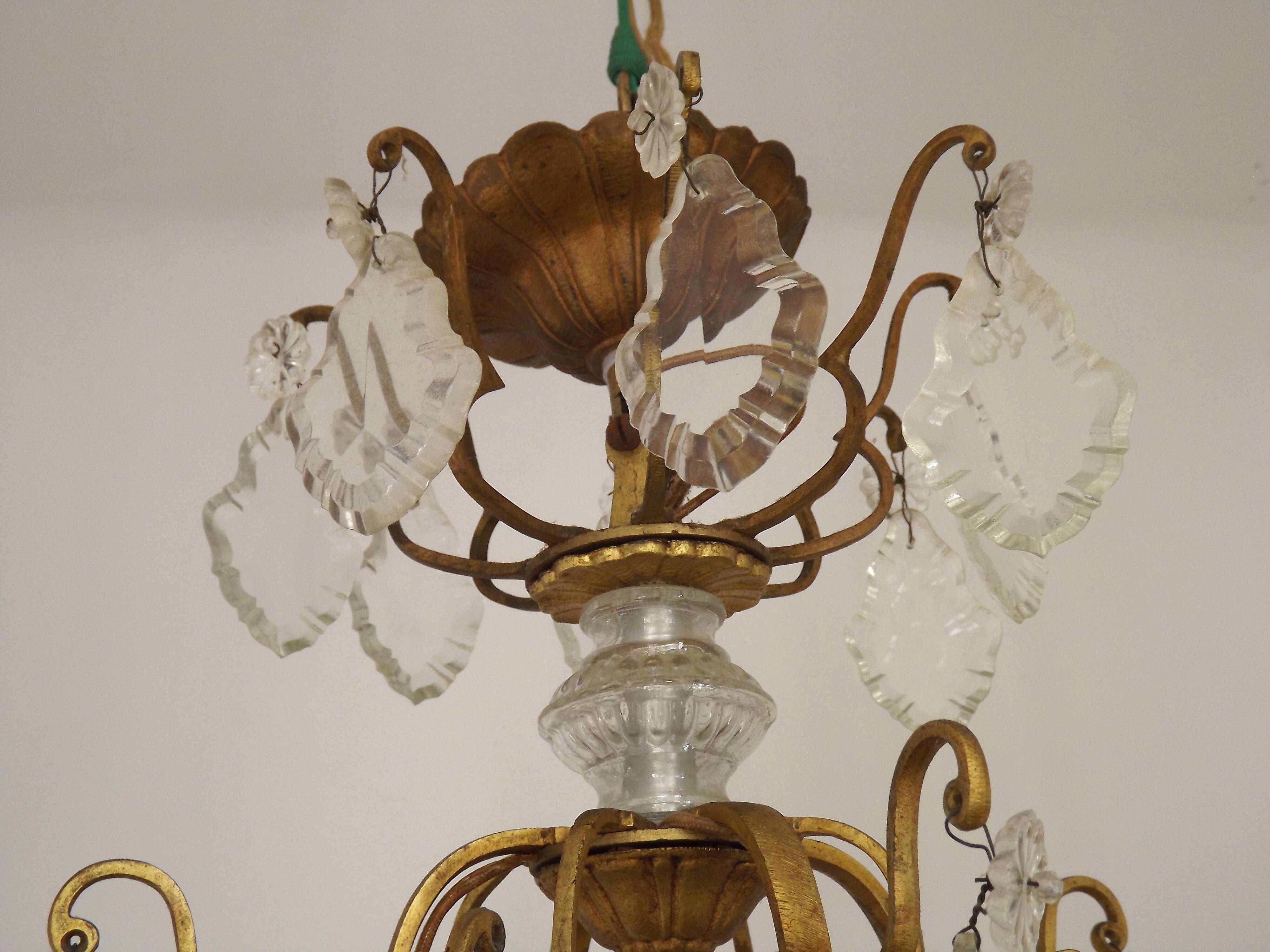 French Louis XV chandelier with 8 lights in gilded bronze, glass and crystal.