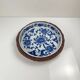 Set of 6 ceramic presentation plates in white and blue, floral pattern with woven wicker frame, 1970s/80s.