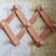 Wall-mounted accordion coat rack in solid pine