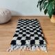 Small Berber rug with black tiles.