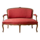 Two-seater Louis XV style sofa in red fabric.