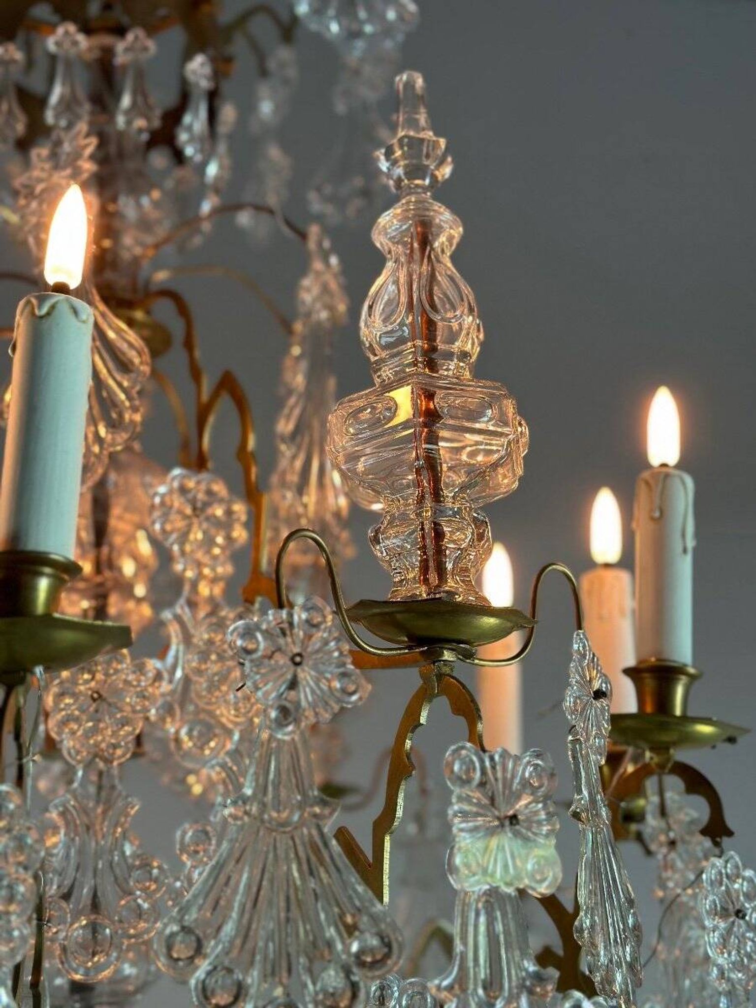 Bronze cage chandelier adorned with molded glass pendants in the shape of peacock feathers, circa 1800