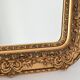 Wooden mirror and gilded stucco decorated with rockery style rinceaux and shells