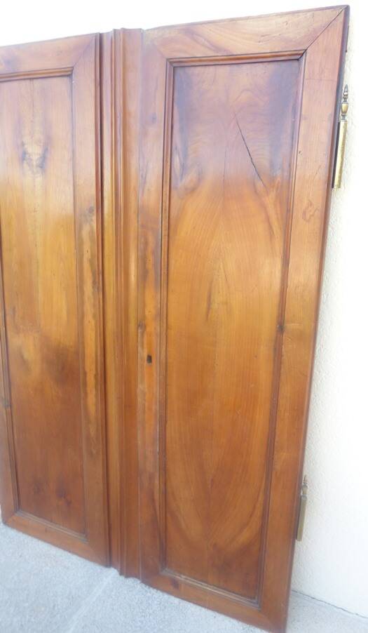 Pair of antique cherry wood cabinet doors from the 19th century in their original part