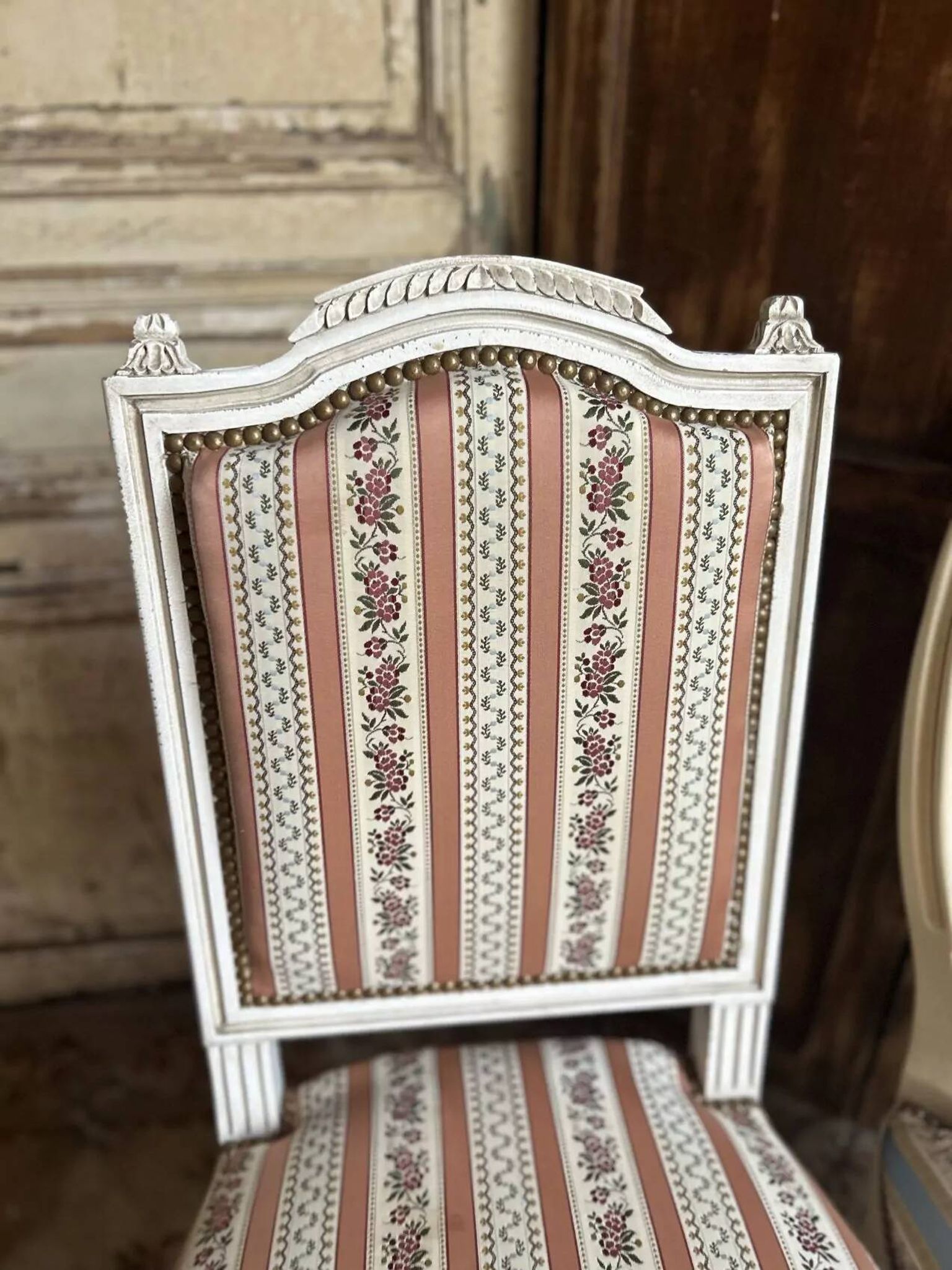 Pair of Louis XVI style chairs in painted wood and satin, classic elegance.