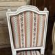 Pair of Louis XVI style chairs in painted wood and satin, classic elegance.