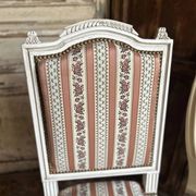 Pair of Louis XVI style chairs in painted wood and satin, classic elegance.