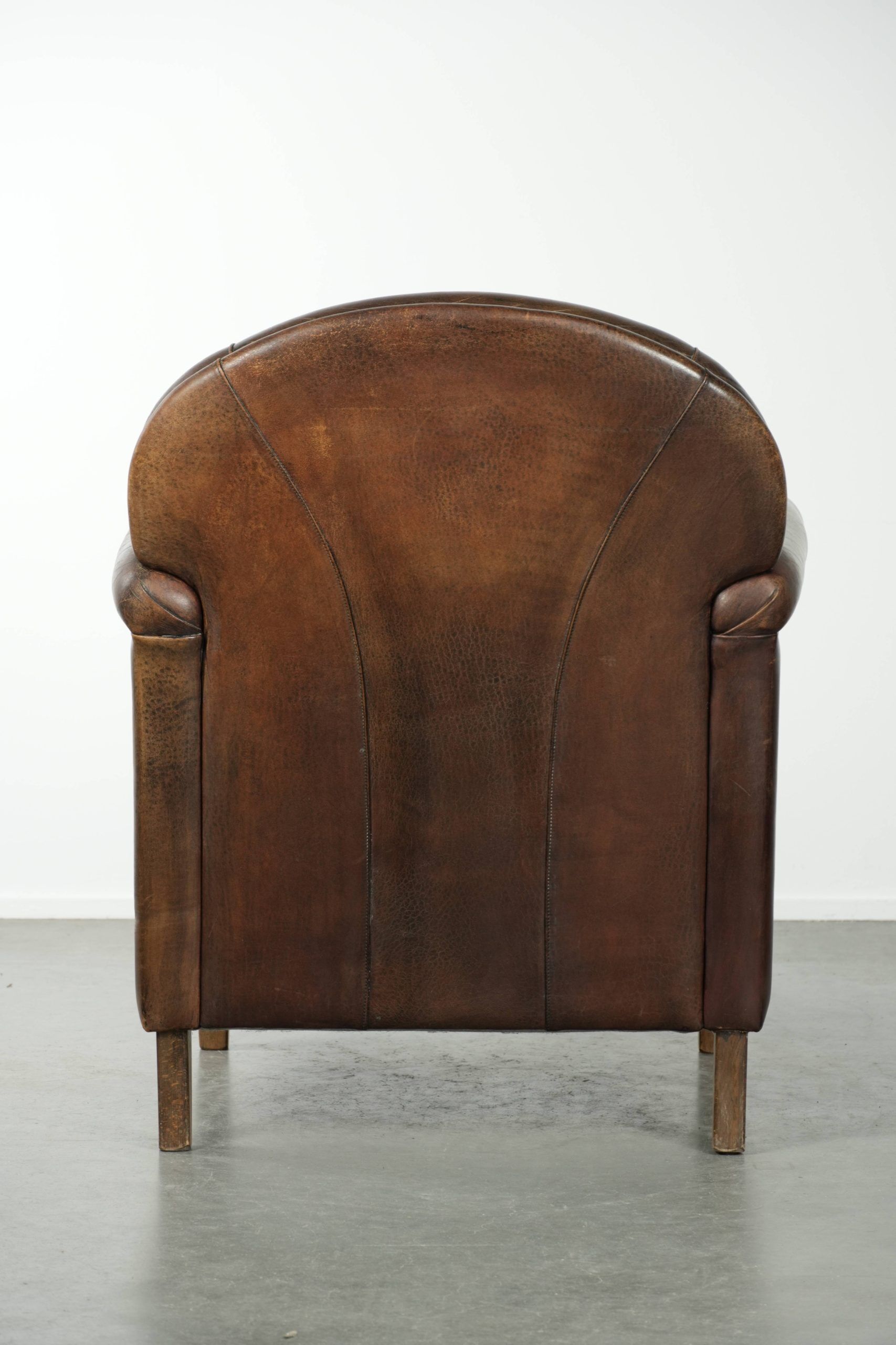 Armchair / lounge chair made of sheepskin leather with characterful patina