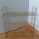 String shelf in golden metal wires