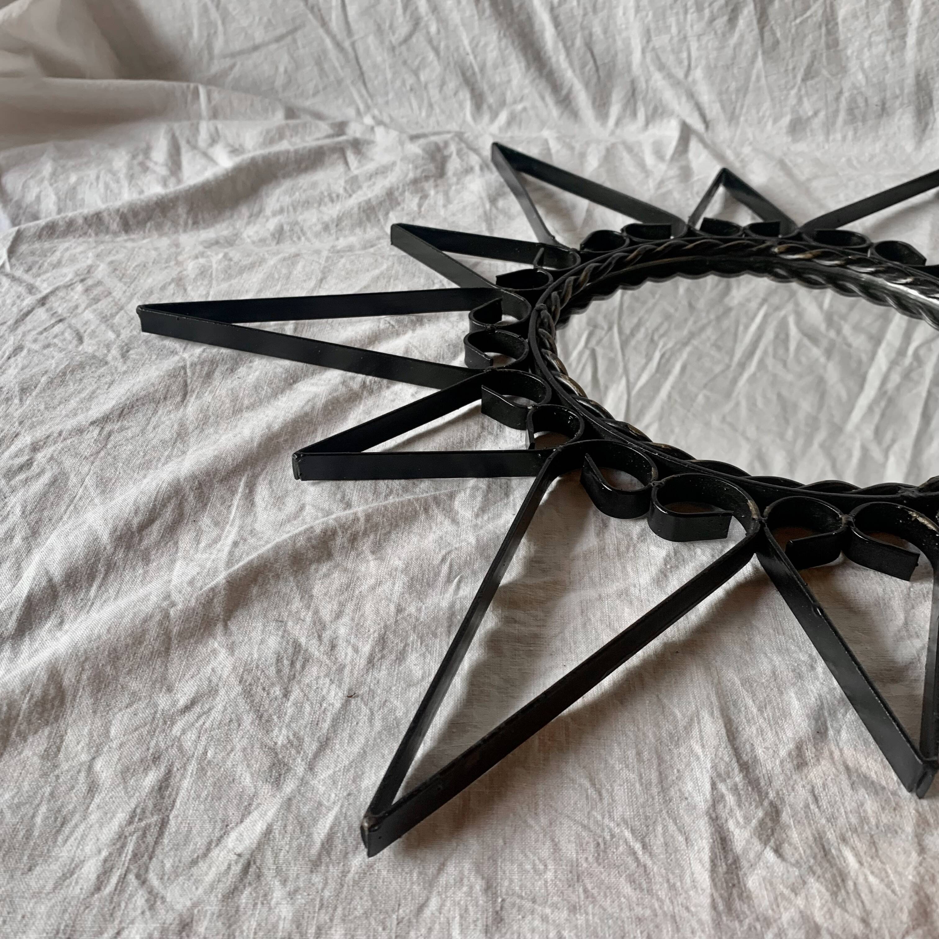 Old wrought metal sun mirror