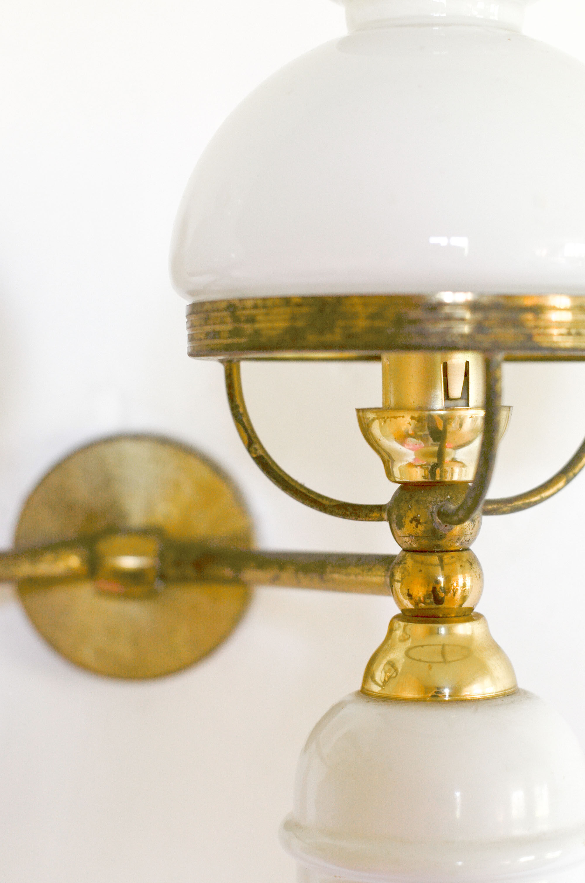 A double brass and opaline wall light