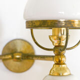 A double brass and opaline wall light