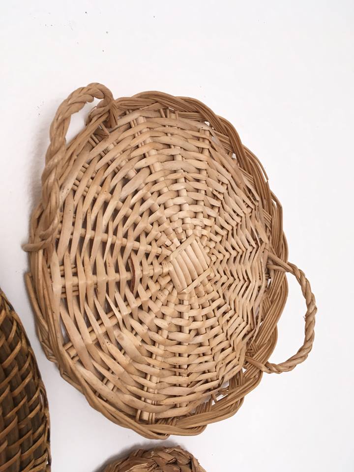Wall composition of seven baskets and wicker trays