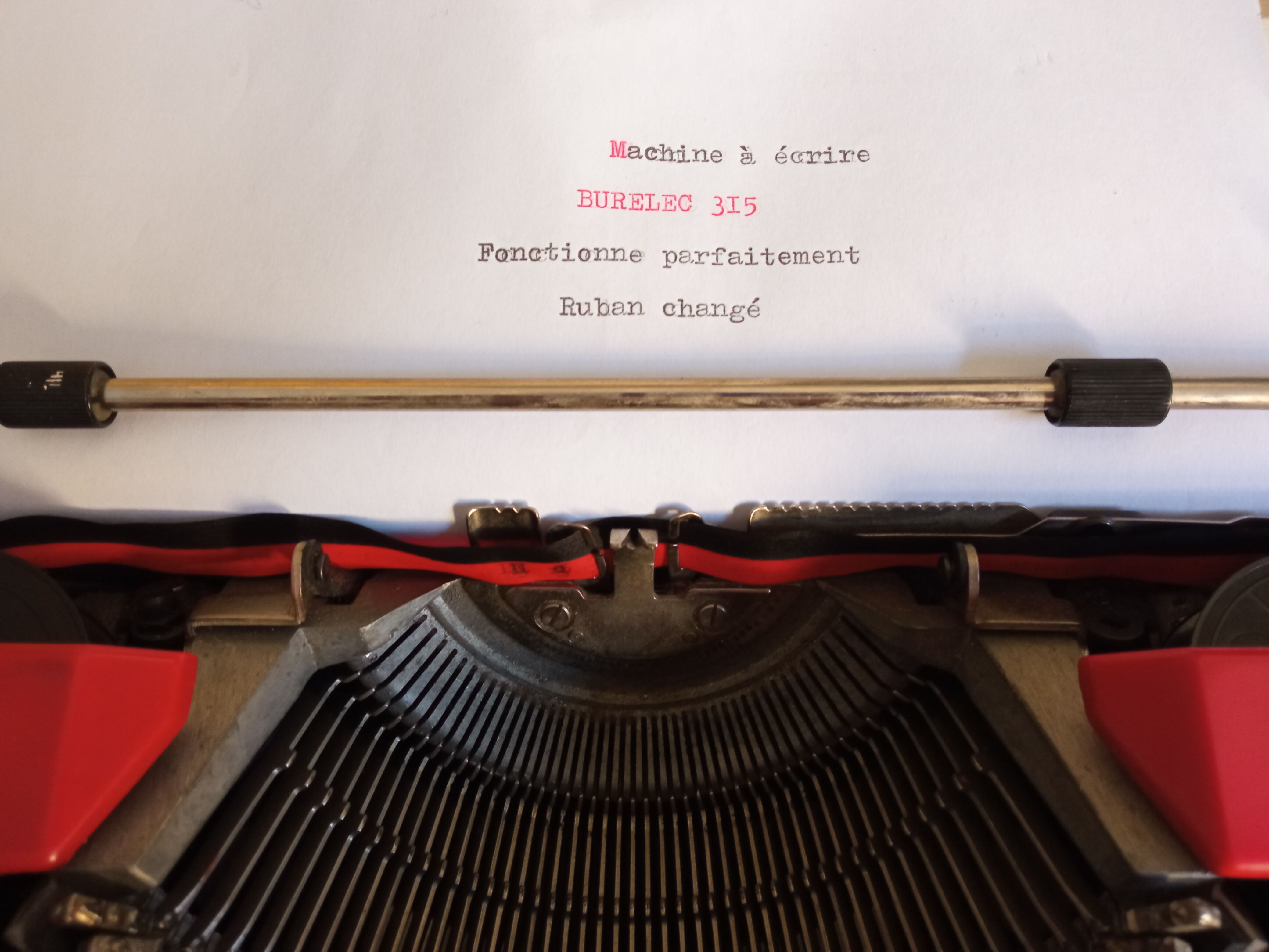 Typewriter "Burelec 315" made in Spain in red and white metal.