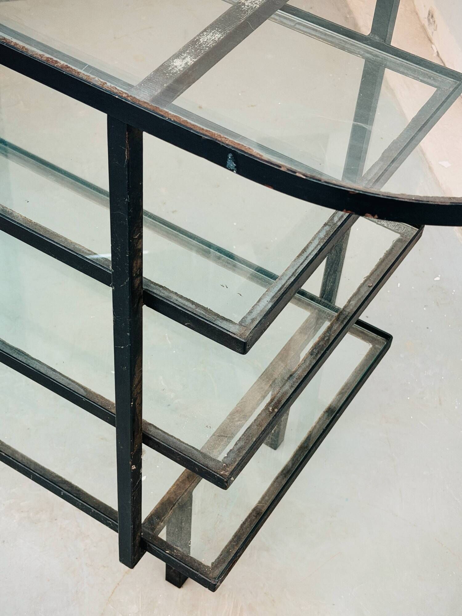Mid-century console with glass top and metal frame.