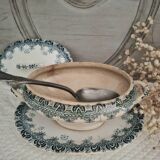 Old iron earthenware sauce boat on frame