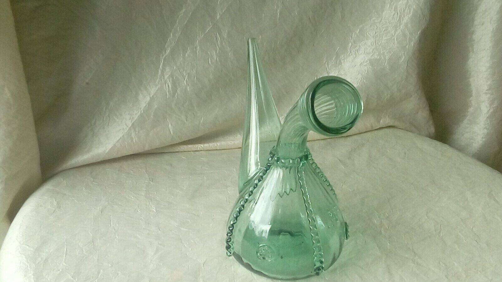 Blown glass carafe with a goat design.