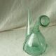 Blown glass carafe with a goat design.