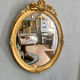 Miroir oval en bois doré 70x49cm