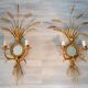 A pair of 1950s wall sconces in gold leaf metal.