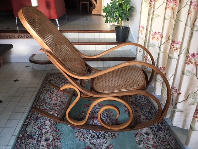 Rocking-chair with cane seating and backrest.