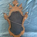 Antique scalloped mirror with pediment decorated with cherubs – carved gilded wood