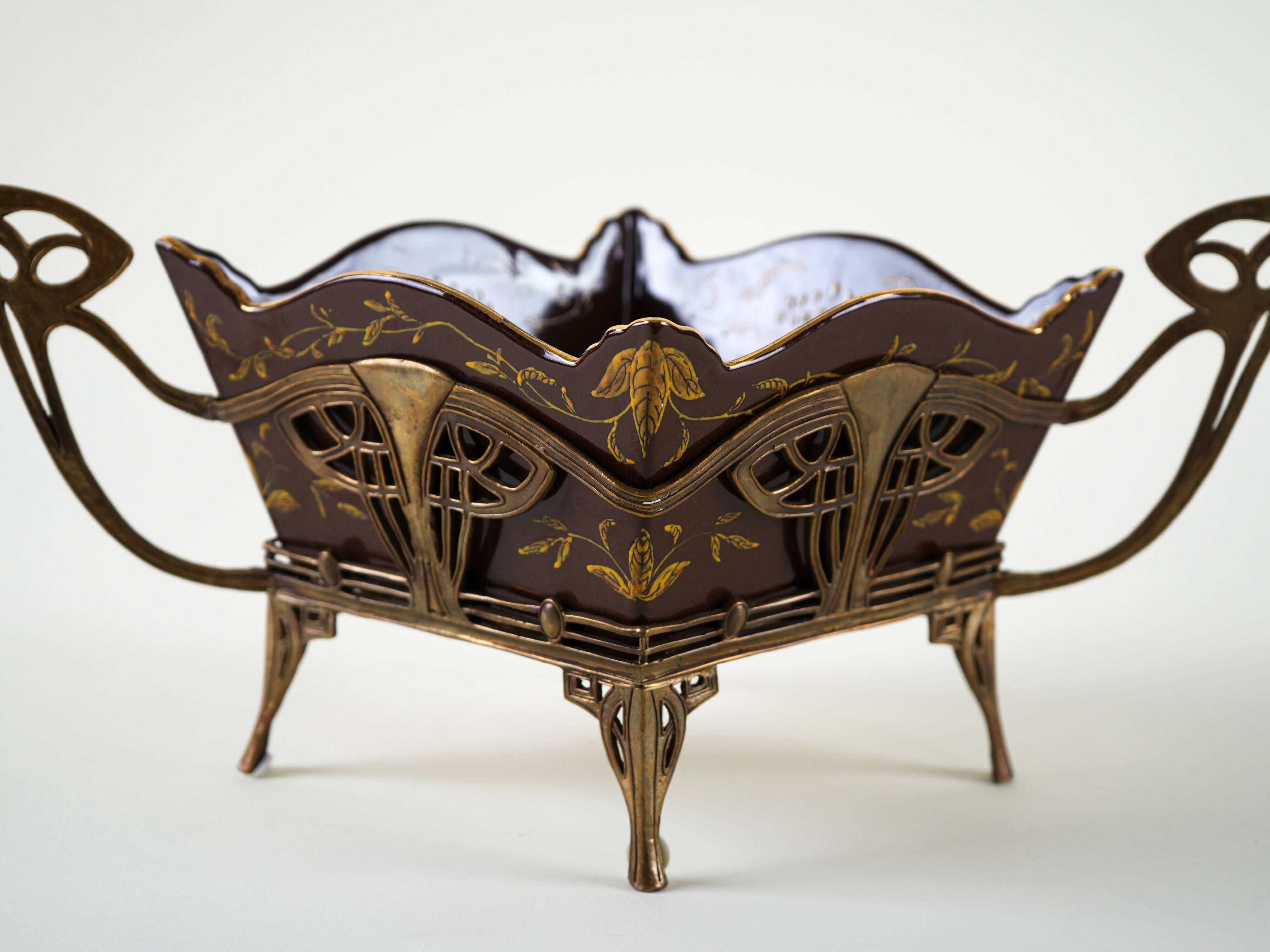 Art Nouveau platter with ceramic insert in openwork metal basket, burgundy glaze with gilt accents