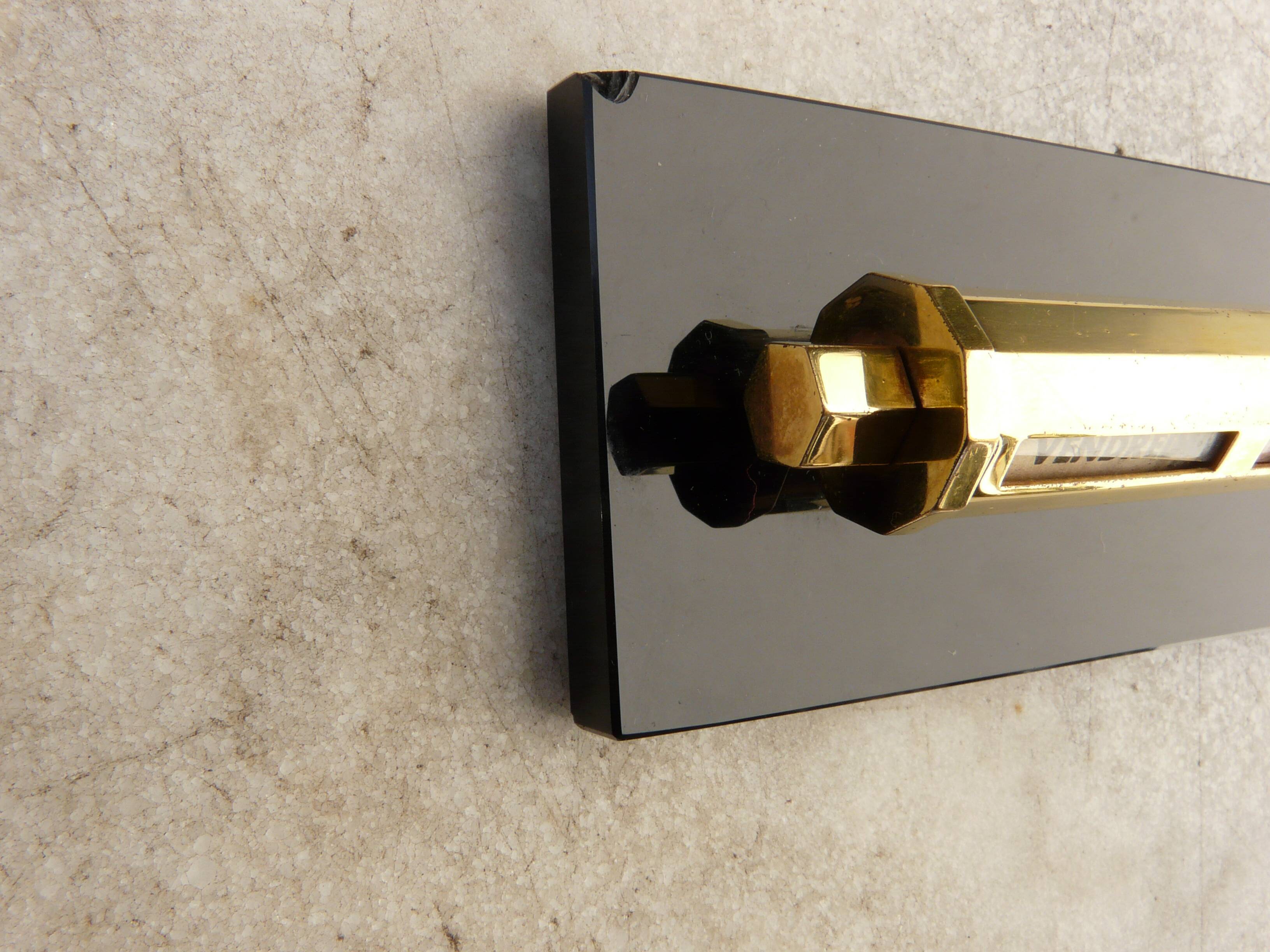 Tubular gold starry perpetual calendar, black base, 1950s